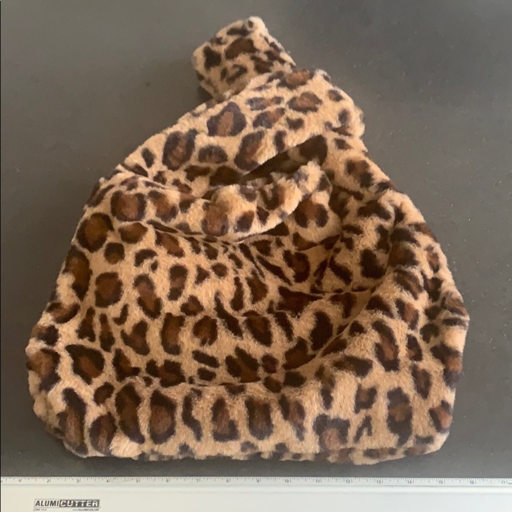Faux leopard fur wrist crossover bag.